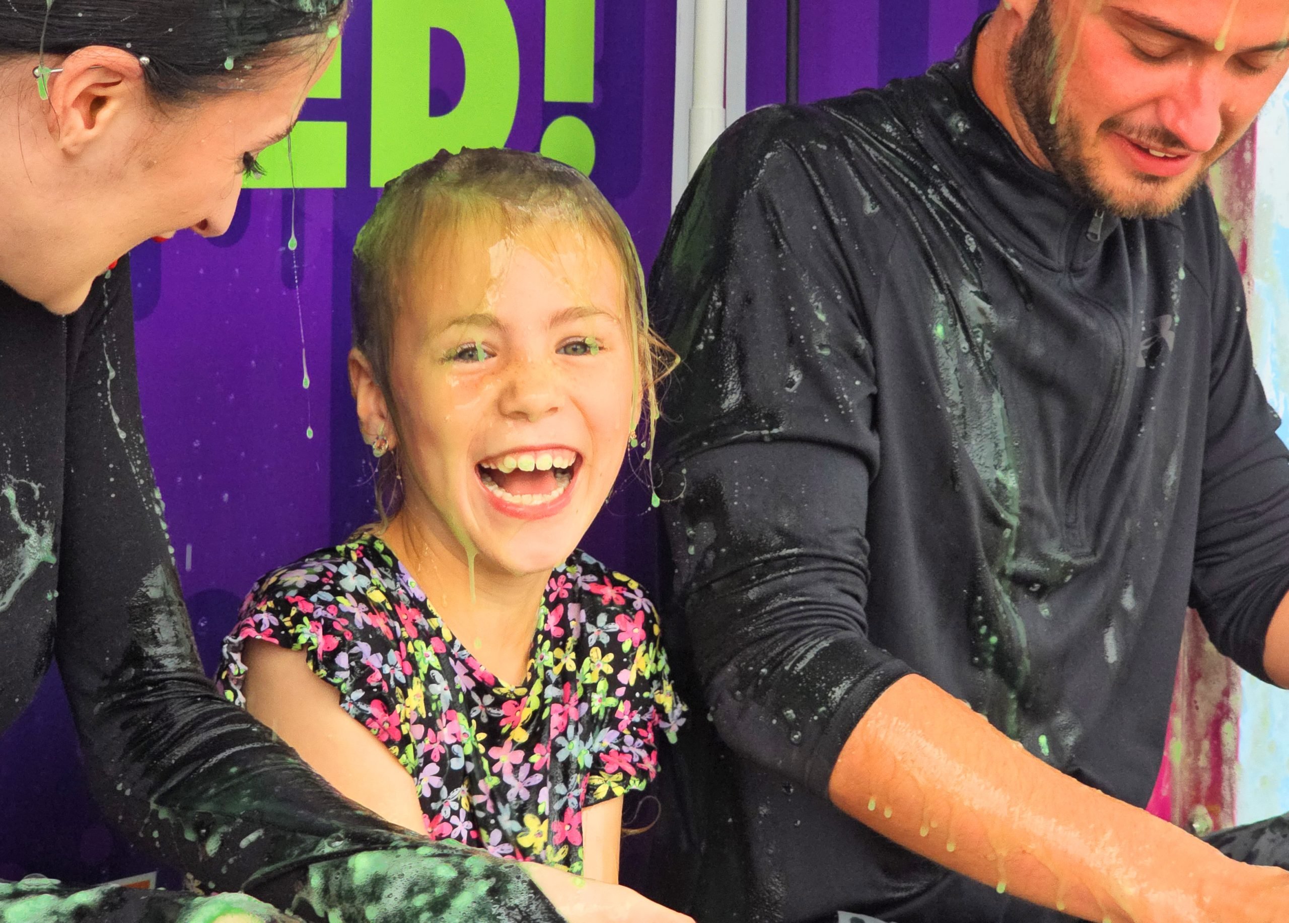 Image of a girl smiling covered in slime.